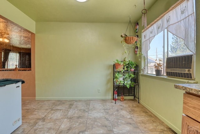 unfurnished dining area with baseboards