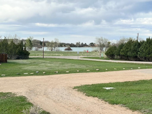 view of property's community featuring a water view and a lawn