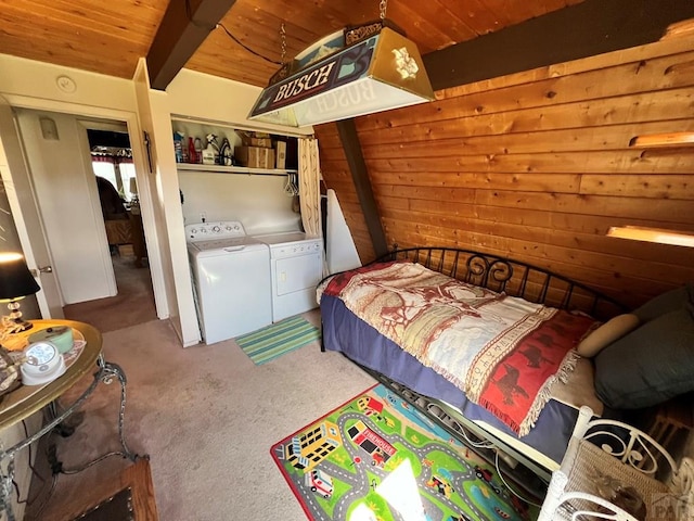 carpeted bedroom with beam ceiling, washing machine and dryer, wood ceiling, and wooden walls