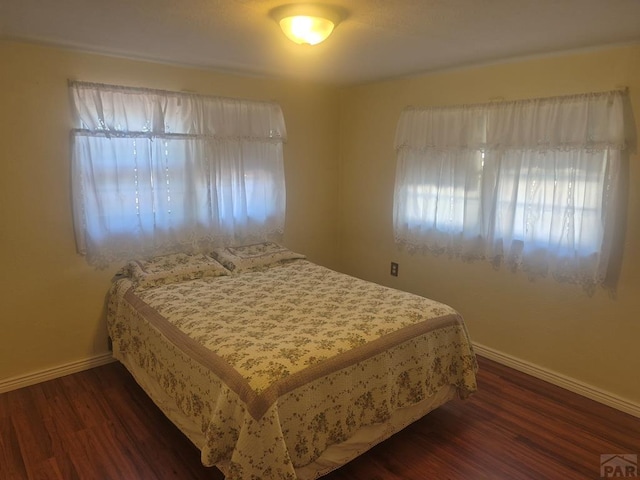 1122 Raton Ave, La Junta, CO 81050 - bedroom featuring multiple windows and wood finished floors