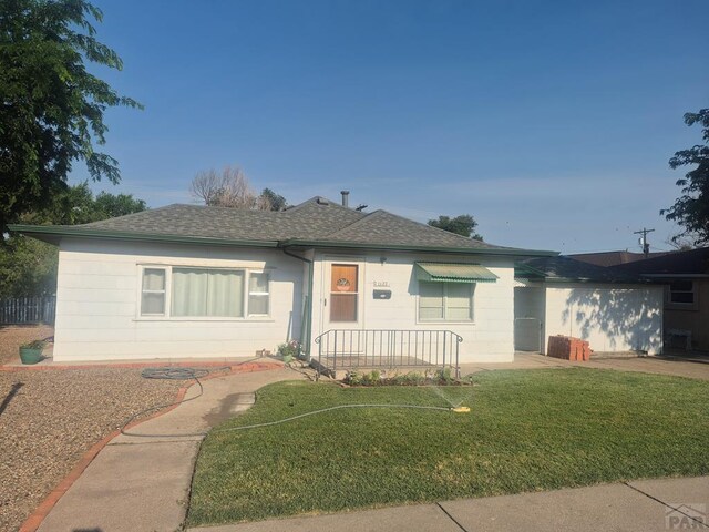 1122 Raton Ave, La Junta, CO 81050 - single story home with a shingled roof and a front lawn