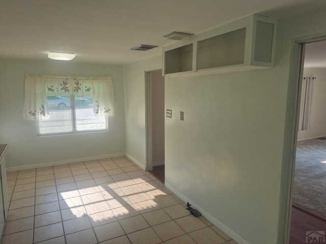 1122 Raton Ave, La Junta, CO 81050 - spare room with light tile patterned flooring and baseboards
