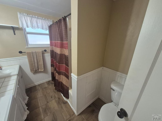 1122 Raton Ave, La Junta, CO 81050 - full bathroom featuring wainscoting, shower / bath combo, and vanity