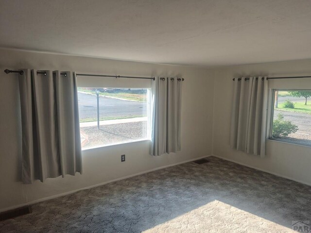 1122 Raton Ave, La Junta, CO 81050 - spare room with carpet floors and baseboards