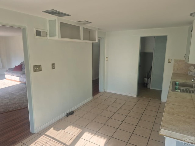 1122 Raton Ave, La Junta, CO 81050 - kitchen featuring light tile patterned floors and tile counters
