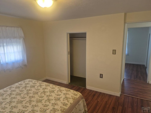 1122 Raton Ave, La Junta, CO 81050 - bedroom with a closet and dark wood-style flooring