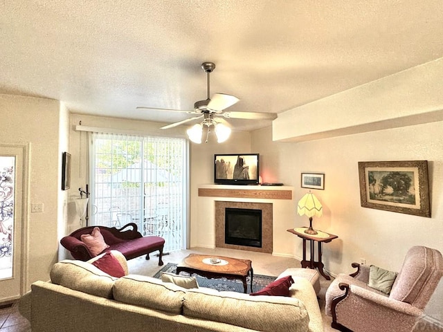 4147 Outlook Blvd Unit F, Pueblo, CO 81008 - living area with a tiled fireplace, a ceiling fan, and a textured ceiling