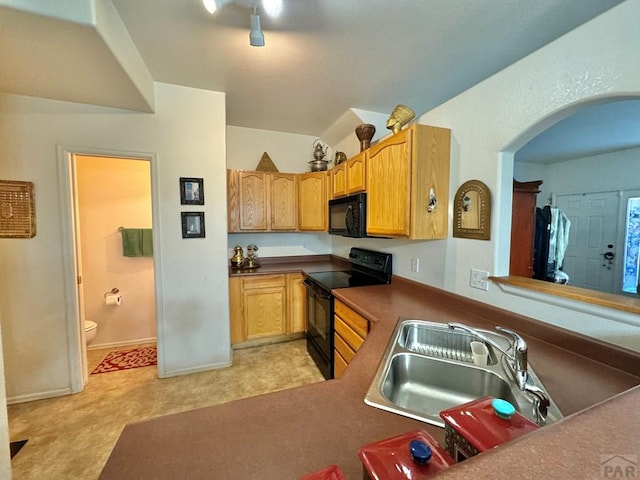 4147 Outlook Blvd Unit F, Pueblo, CO 81008 - kitchen with baseboards, arched walkways, a sink, and black appliances