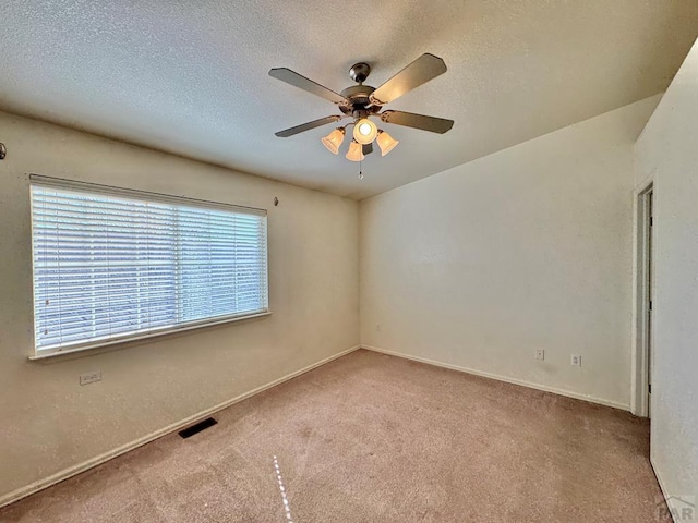 4147 Outlook Blvd Unit F, Pueblo, CO 81008 - carpeted empty room with visible vents, a textured ceiling, baseboards, and ceiling fan