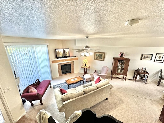 4147 Outlook Blvd Unit F, Pueblo, CO 81008 - carpeted living room featuring a fireplace, a textured ceiling, and ceiling fan