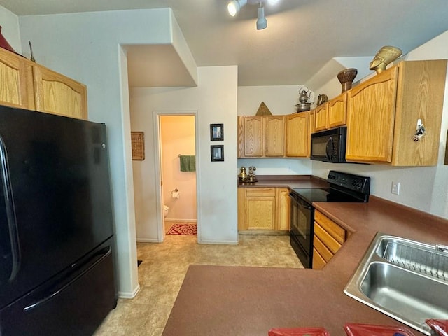 4147 Outlook Blvd Unit F, Pueblo, CO 81008 - kitchen with baseboards, light brown cabinets, a sink, and black appliances