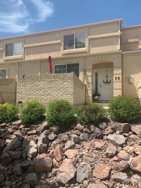 4147 Outlook Blvd Unit F, Pueblo, CO 81008 - view of front of property with stucco siding and fence
