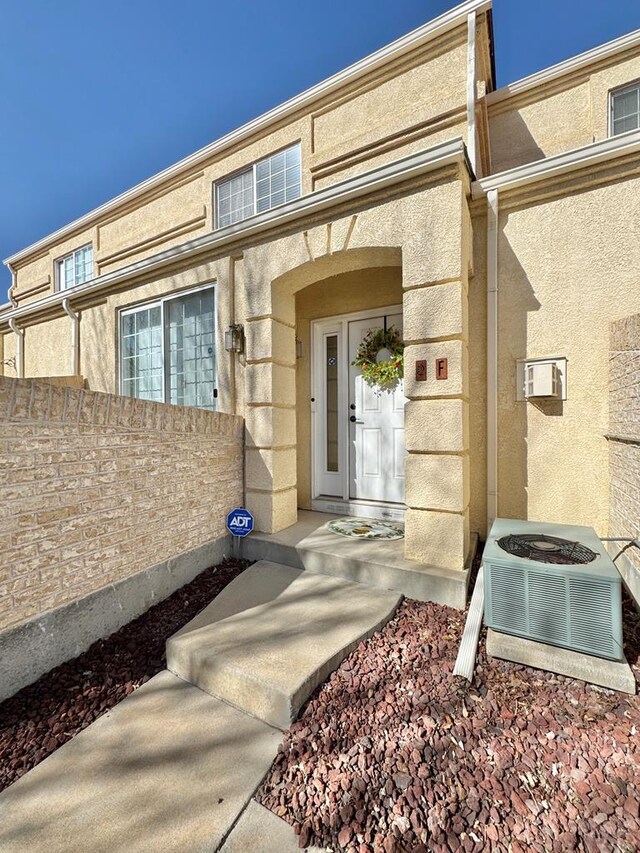 4147 Outlook Blvd Unit F, Pueblo, CO 81008 - entrance to property featuring central AC, fence, and stucco siding