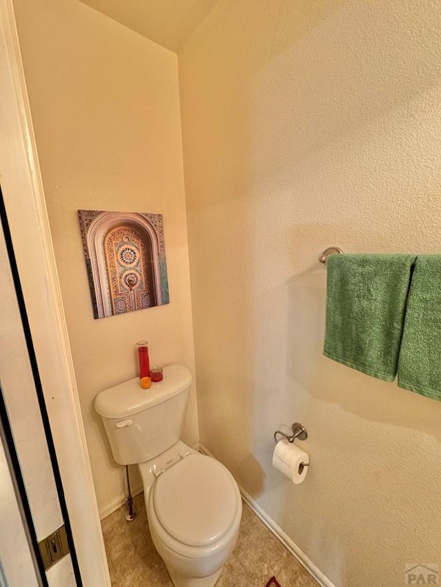 4147 Outlook Blvd Unit F, Pueblo, CO 81008 - bathroom featuring tile patterned flooring, baseboards, and toilet