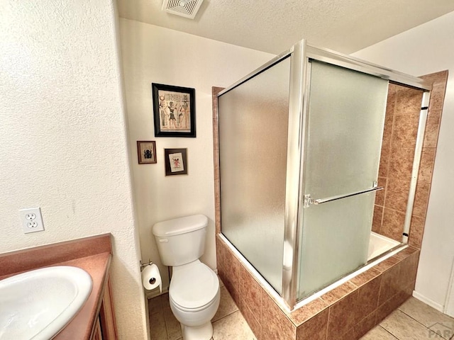 4147 Outlook Blvd Unit F, Pueblo, CO 81008 - bathroom featuring vanity, tiled shower / bath combo, visible vents, and a textured ceiling