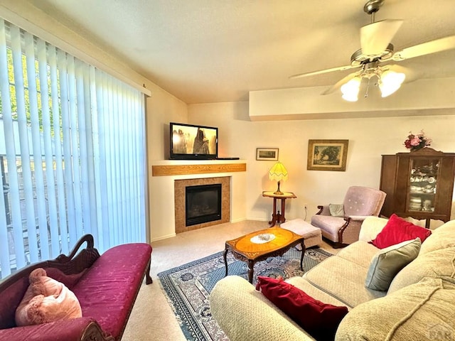 4147 Outlook Blvd Unit F, Pueblo, CO 81008 - carpeted living area with a tile fireplace and a ceiling fan