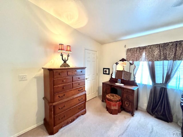 4147 Outlook Blvd Unit F, Pueblo, CO 81008 - bedroom with light carpet, baseboards, and lofted ceiling