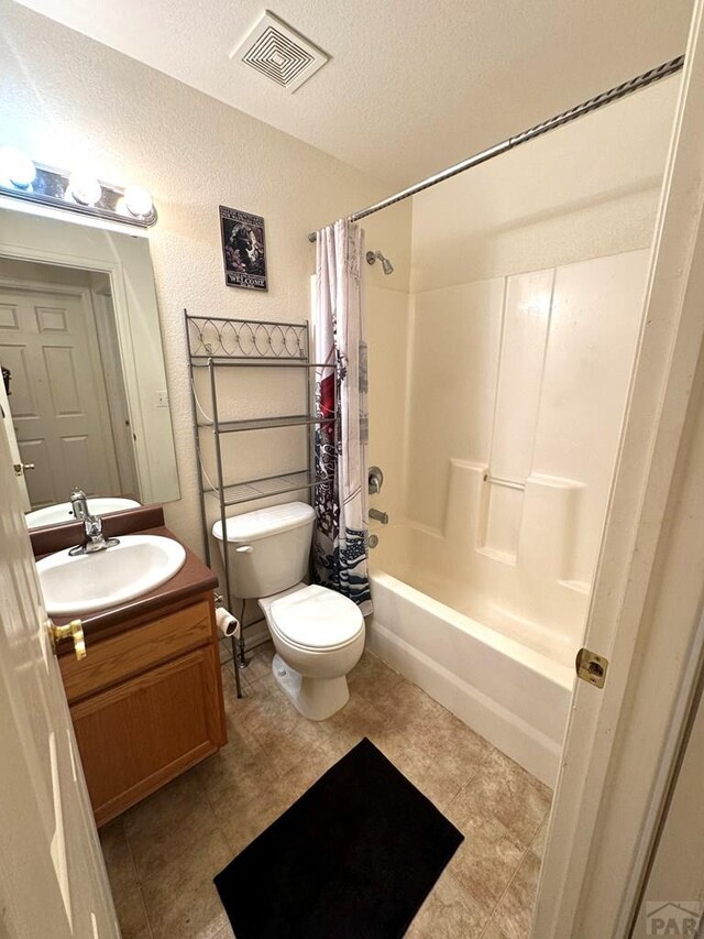4147 Outlook Blvd Unit F, Pueblo, CO 81008 - full bath featuring vanity, a textured wall, shower / tub combo with curtain, a textured ceiling, and visible vents