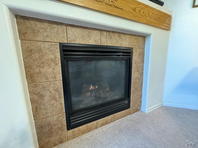 4147 Outlook Blvd Unit F, Pueblo, CO 81008 - room details with a tile fireplace and carpet floors