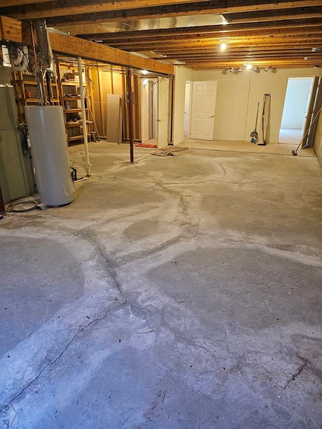 unfinished below grade area featuring water heater