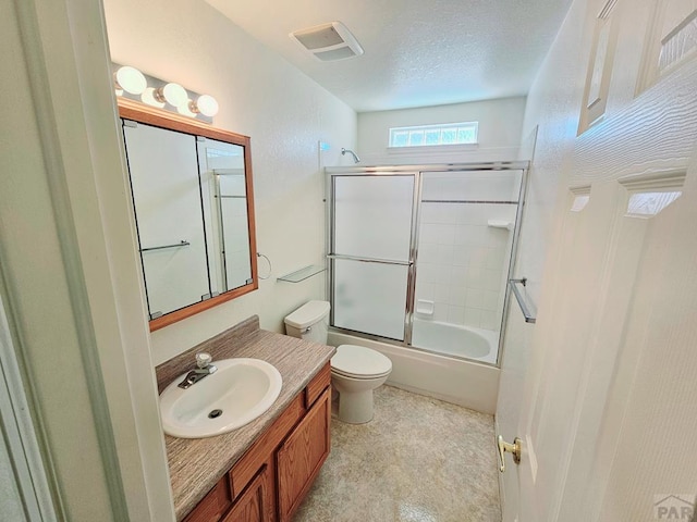 full bath featuring visible vents, toilet, enclosed tub / shower combo, vanity, and a textured ceiling