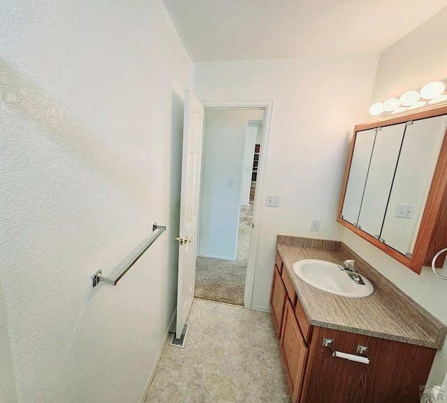 bathroom featuring visible vents, vanity, and baseboards