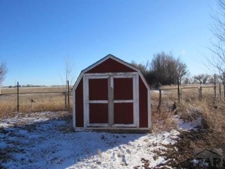 view of shed with a rural view