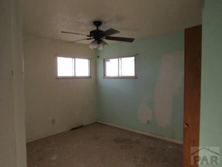 unfurnished room featuring a ceiling fan