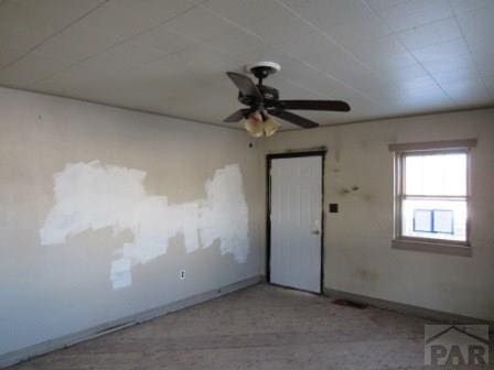 unfurnished room with baseboards and a ceiling fan