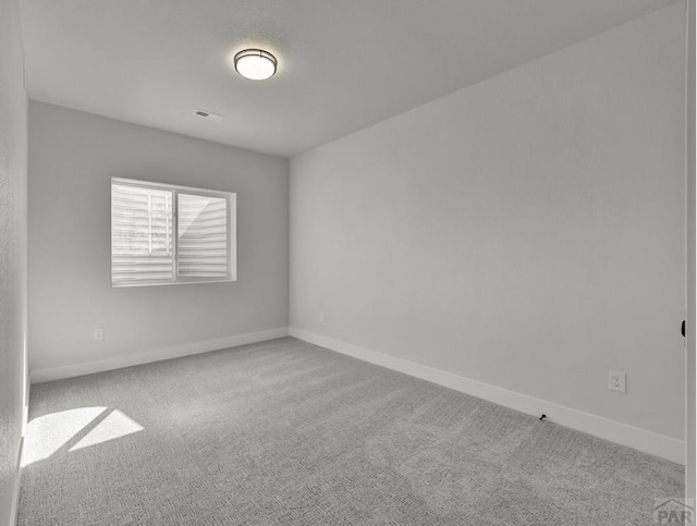 unfurnished room featuring light carpet, visible vents, and baseboards