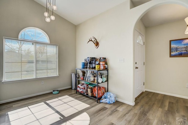 5019 Sage St, Pueblo, CO 81005 - dining space featuring arched walkways, wood finished floors, baseboards, and lofted ceiling