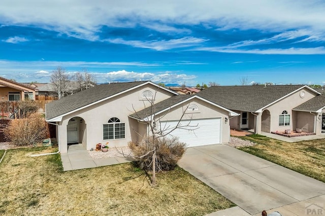 5019 Sage St, Pueblo, CO 81005 - single story home featuring an attached garage, stucco siding, a front lawn, and concrete driveway