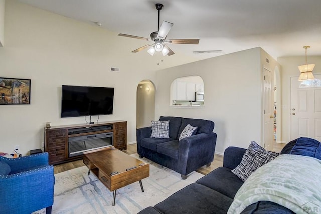 5019 Sage St, Pueblo, CO 81005 - living room featuring light wood finished floors, ceiling fan, and arched walkways
