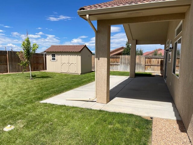 view of patio / terrace featuring a shed, an outdoor structure, and a fenced backyard