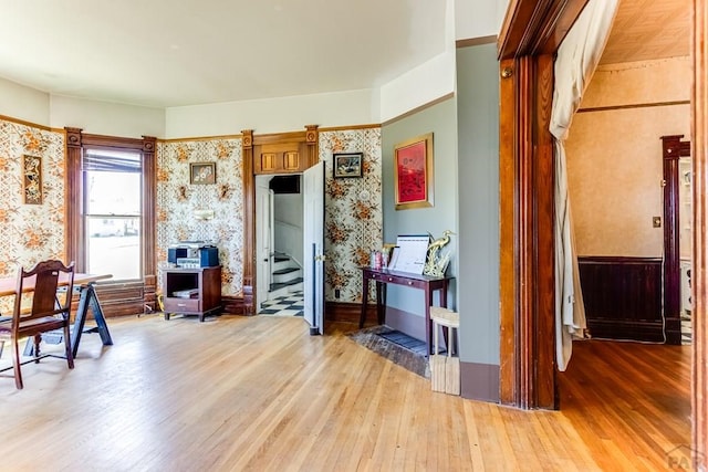 interior space with wallpapered walls and light wood-type flooring