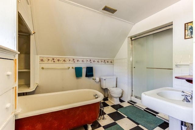full bathroom featuring toilet, tile patterned floors, vaulted ceiling, visible vents, and a soaking tub