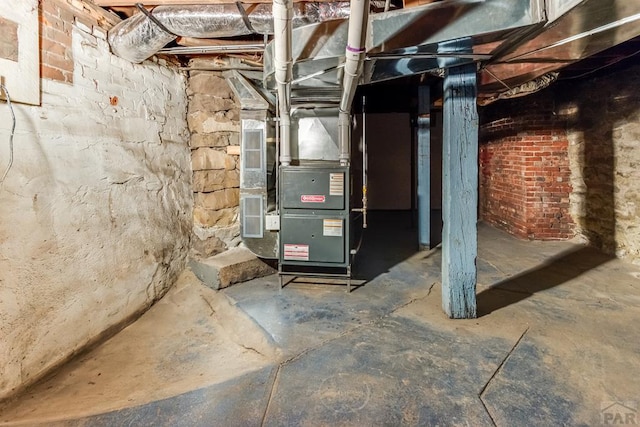 utility room featuring heating unit