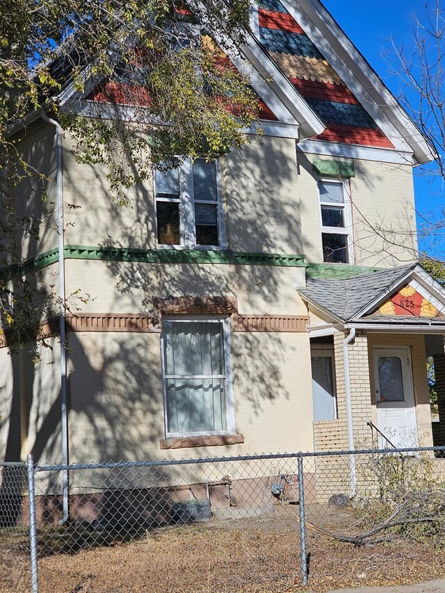 view of home's exterior with a fenced front yard and brick siding