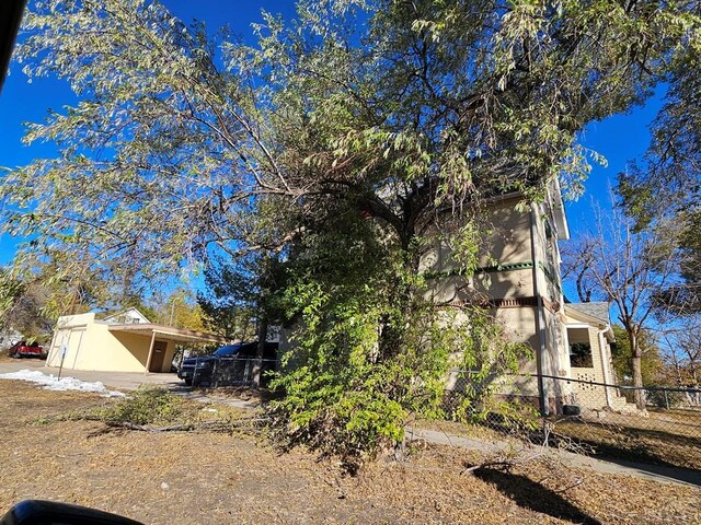 view of property exterior with fence and stucco siding