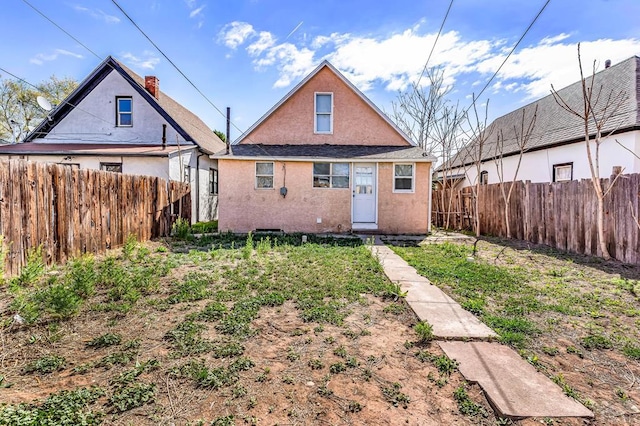 1131 Pine St, Pueblo, CO 81004 - back of house with a fenced backyard and stucco siding