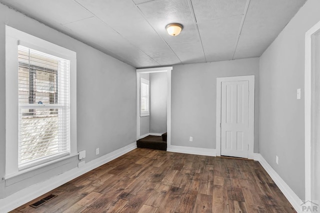 1131 Pine St, Pueblo, CO 81004 - unfurnished bedroom featuring baseboards, dark wood-type flooring, and visible vents