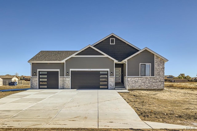 view of front facade with stone siding, concrete driveway, and an attached garage