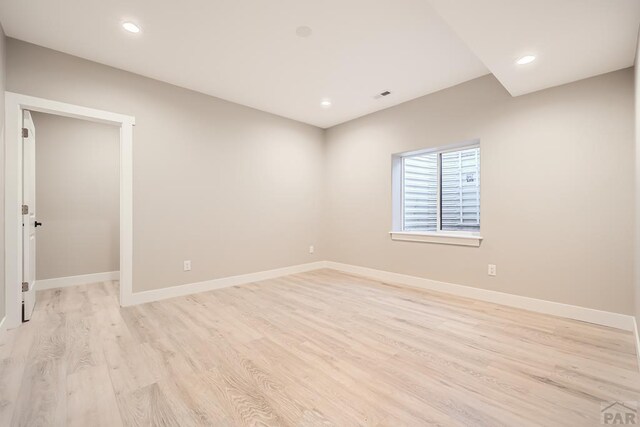 unfurnished room featuring light wood-type flooring, baseboards, and recessed lighting