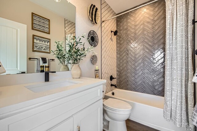 bathroom featuring shower / bath combo, vanity, and toilet