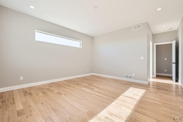 empty room featuring baseboards, recessed lighting, visible vents, and light wood-style floors