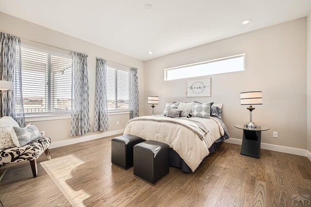 bedroom featuring recessed lighting, wood finished floors, and baseboards