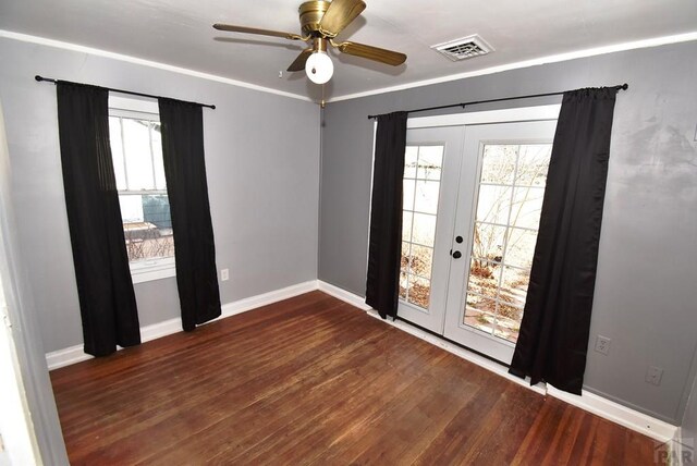 unfurnished room featuring ceiling fan, dark wood-style flooring, visible vents, baseboards, and french doors