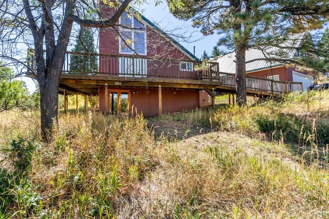 back of property with a wooden deck