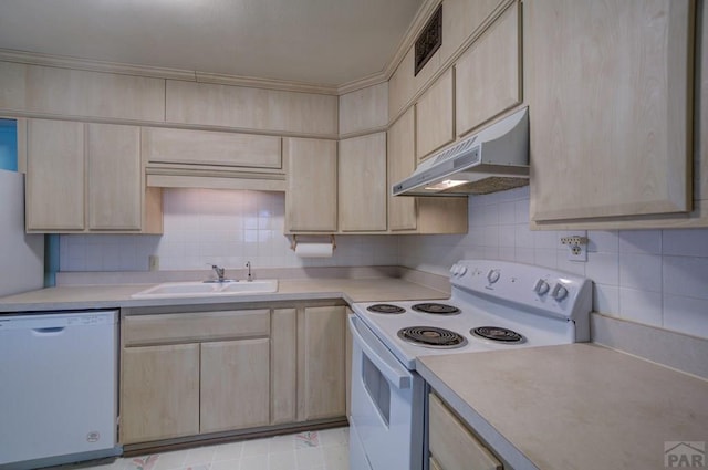 2621 Begonia St, Pueblo, CO 81005 - kitchen with light brown cabinets, under cabinet range hood, a sink, and white appliances