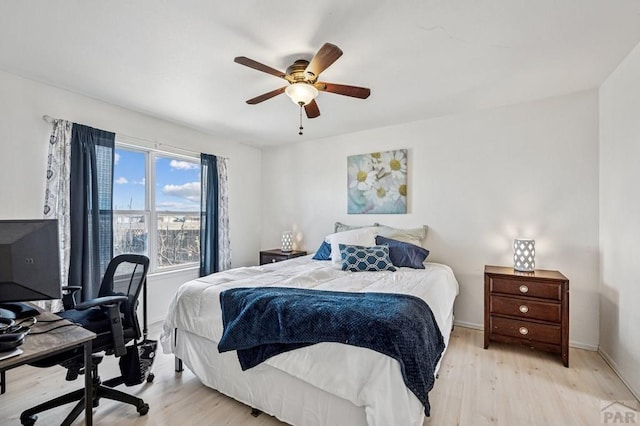 bedroom with light wood-type flooring, baseboards, and ceiling fan